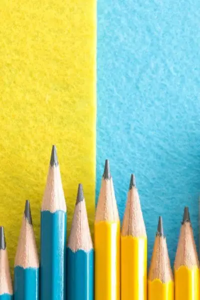 Blue and yellow pencils on a blue and yellow background.
