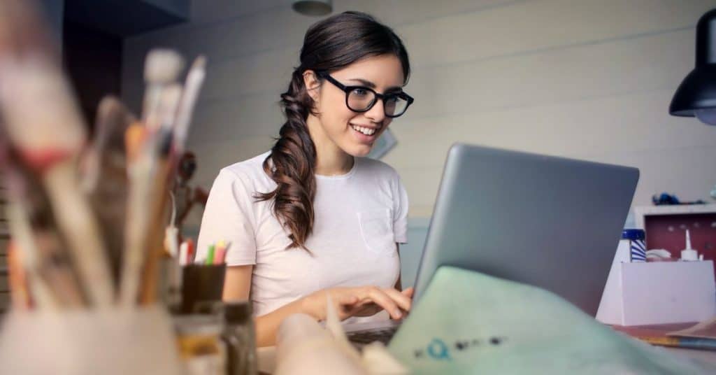 An art teacher checking her email: one of the self care challenge for teachers ideas is to only check your email at set times per day.