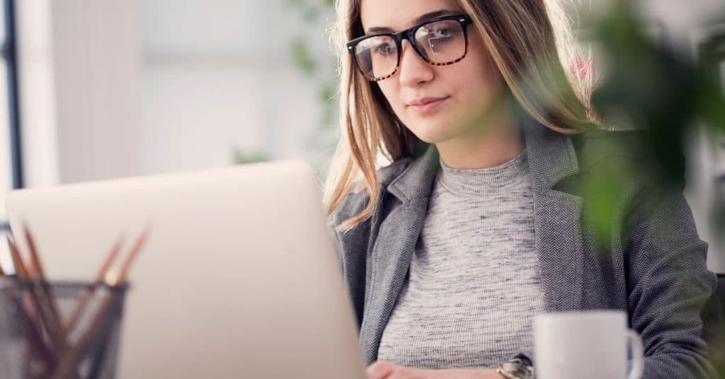 Woman sitting at her computer as part of her start work ritual