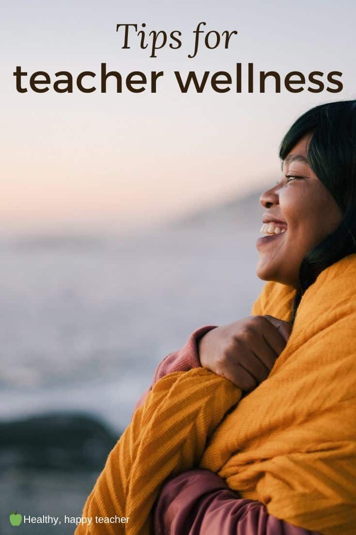 A black woman outside with a blanket wrapped around her and the text overlay tips for teacher wellness.