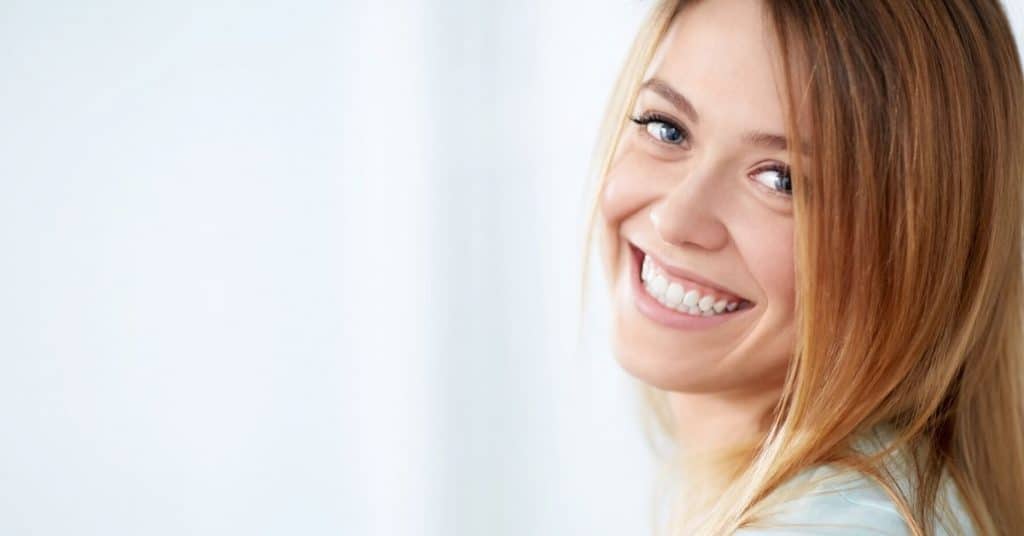 A young blond woman smiling at the camera.