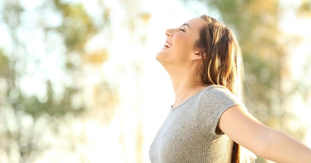 Teacher standing outside deep breathing and repeating teaching mantras