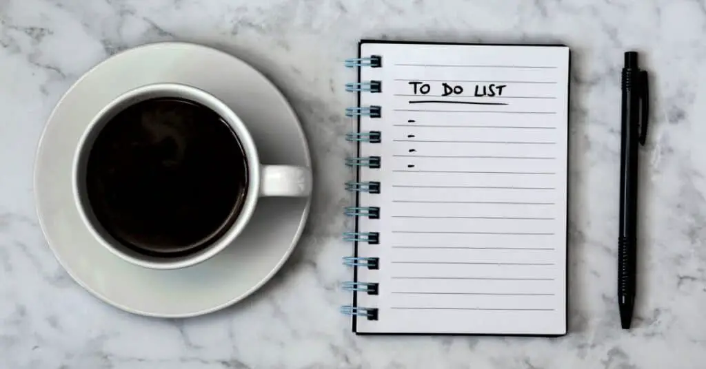 A to do list next to a cup of coffee