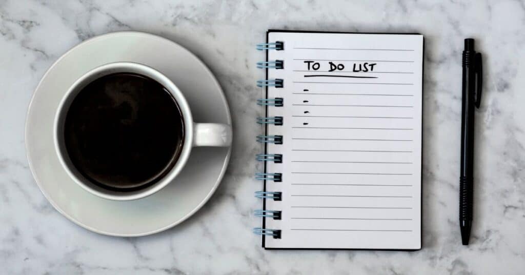 A to do list next to a cup of coffee