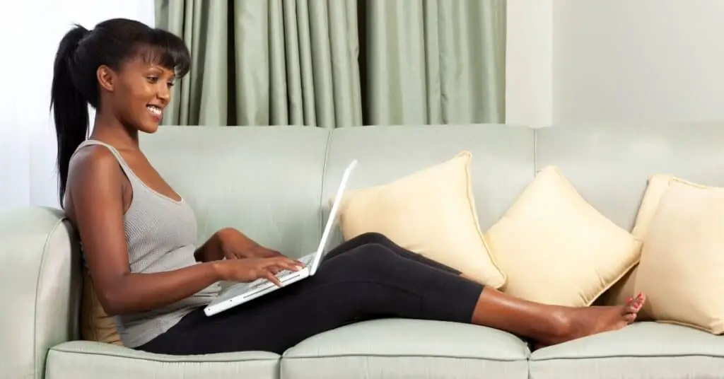 Woman on a couch with a laptop