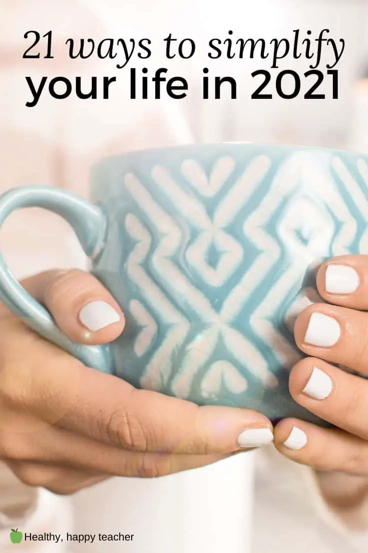 A woman's hand holding a blue cup with the text overlay, 21 ways to simplify your life in 2021.