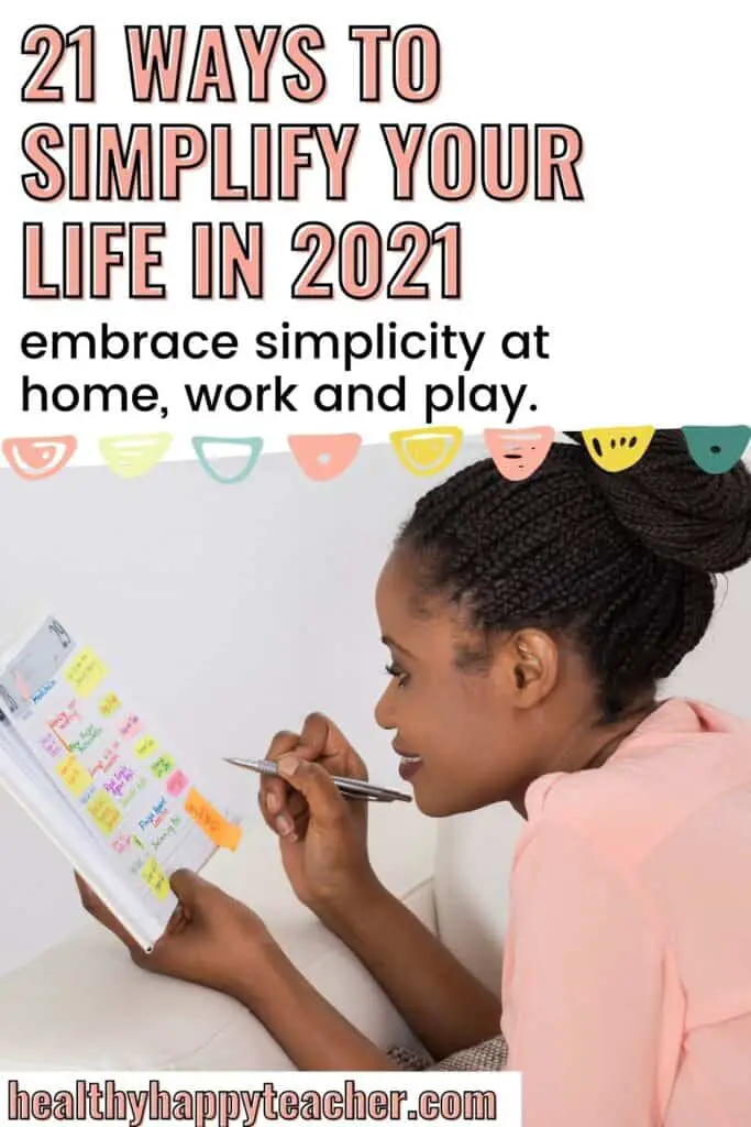 Black woman looking at her planner with the text overlay, 21 ways to simplify your life in 2021.