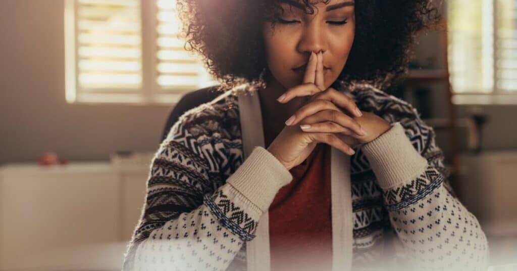 Black woman with eyes closed focusing on breathing