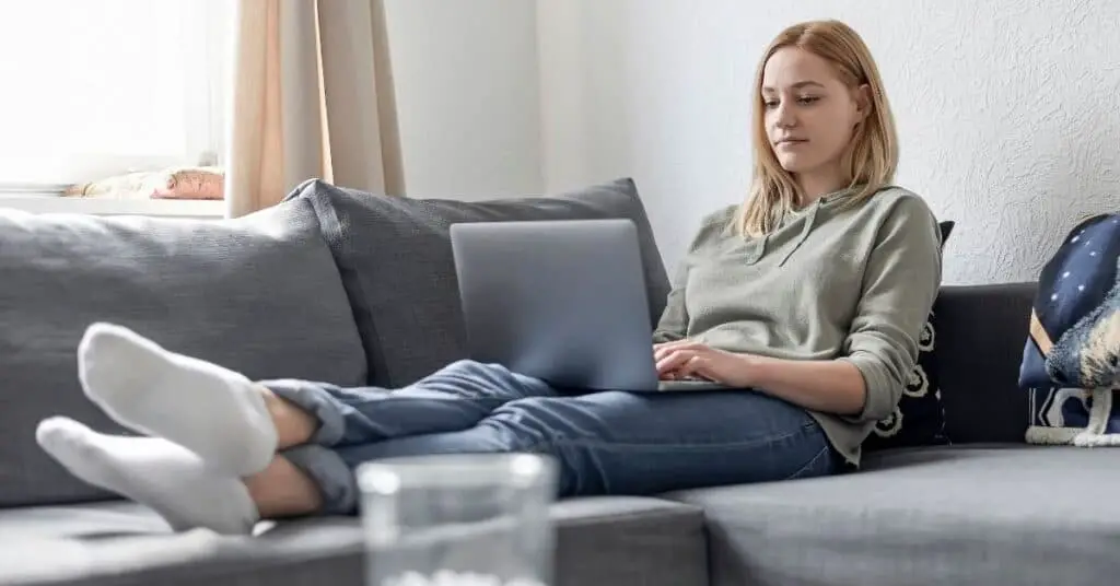 Woman on her laptop on the couch.