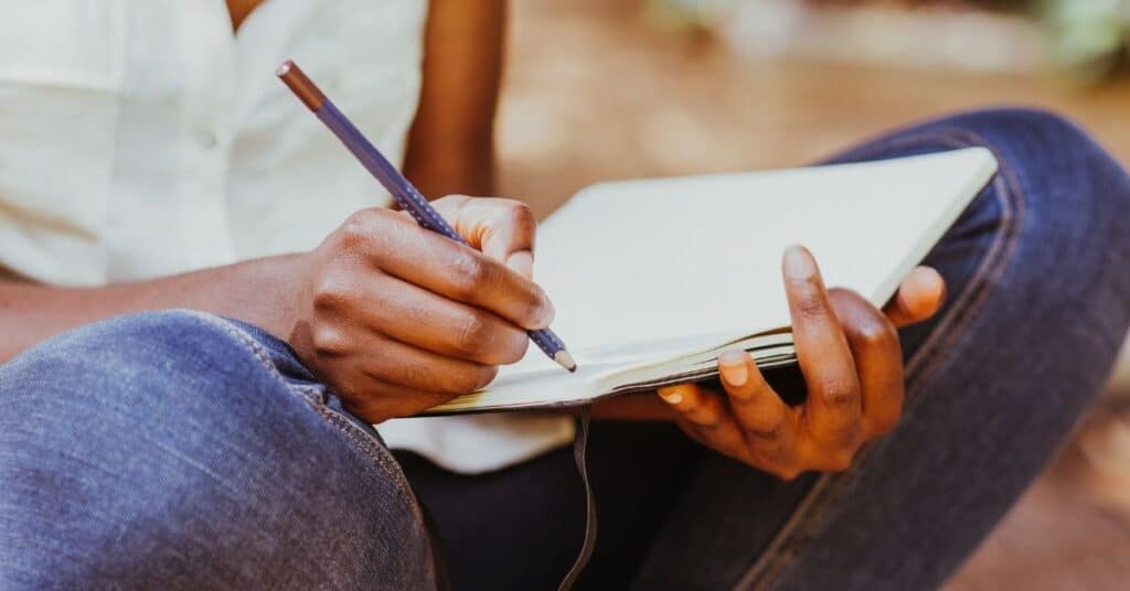 Woman working on her goals in a planner.