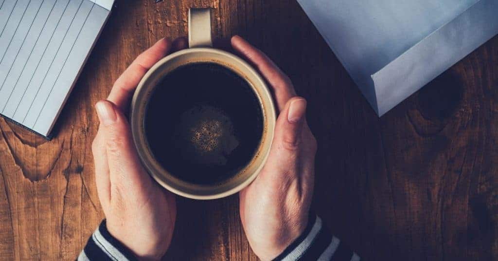 woman holding a cup of coffee in her hands